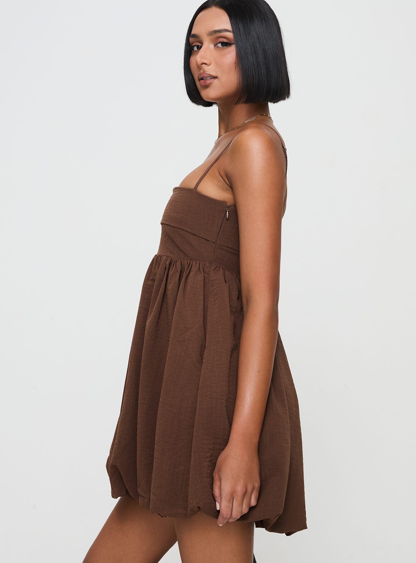 side view of model wearing Princess Polly Layken Bubble Hem Mini Dress Chocolate Petite Square Neck 