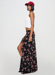   side view of model wearing Princess Polly Rhomana Maxi Skirt Black Floral Maxi 