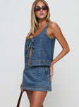 side view of model wearing Princess Polly Stefenie Denim Skort Mid Wash Low Rise Shorts 