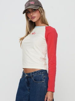 side view of model wearing Princess Polly Racing Star Long Sleeve Top Red Full Sleeves Crew Neck 