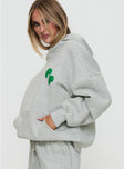 side view of model wearing Princess Polly Princess Polly Hooded Sweatshirt Bubble Text Grey Marle / Green 