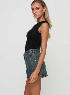 side view of model wearing Princess Polly Get It Right Mid Rise Denim Shorts Dark Denim Wash High Waisted Shorts 