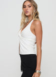 side view of model wearing Princess Polly Fontanne Twist Top White Sleeveless Plunger 