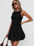 side view of model wearing Princess Polly Demure Shirred Bubble Hem Mini Dress Black Scoop Neck 