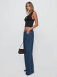 side view of model wearing Princess Polly Ramos Low Rise Denim Jeans Dark Blue Wash Low Rise Jeans 