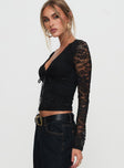 side view of model wearing Princess Polly Temptation Incoming Long Sleeve Lace Top Black Full Sleeves V-Neck 