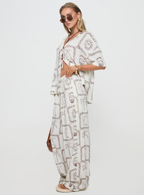 side view of model wearing Princess Polly Sun Dream Pants Cream / Multi High Waisted Pants 