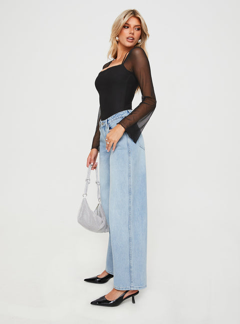 side view of model wearing Princess Polly Maryanne Mid-rise Relaxed Jeans Light Wash High Waisted 