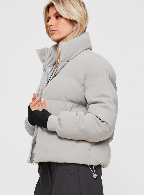 Ribbed puffer jacket High neckline, twin hip pockets, zip fastening down front, drawstring waist, elasticated cuffs