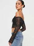 Lace long sleeve top Off the shoulder design, tie fastening at bust, flared cuff Good stretch, unlined, sheer