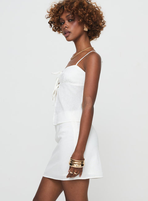 Two-piece linen set Top, adjustable shoulder straps, twin tie fastening at bust, split hem High rise mini skirt, invisible zip fastening down side Non-stretch material, partially lined