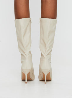 Cream Knee-high boots Faux leather material, zip fastening at inside, pointed toe, stiletto heel