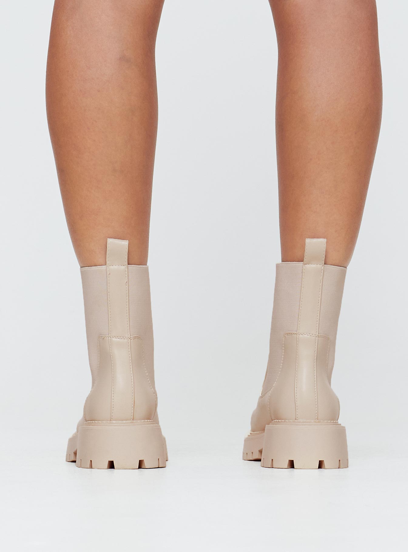 Faux leather boots Rounded toe, treaded sole, pull tab at back, passed footbed