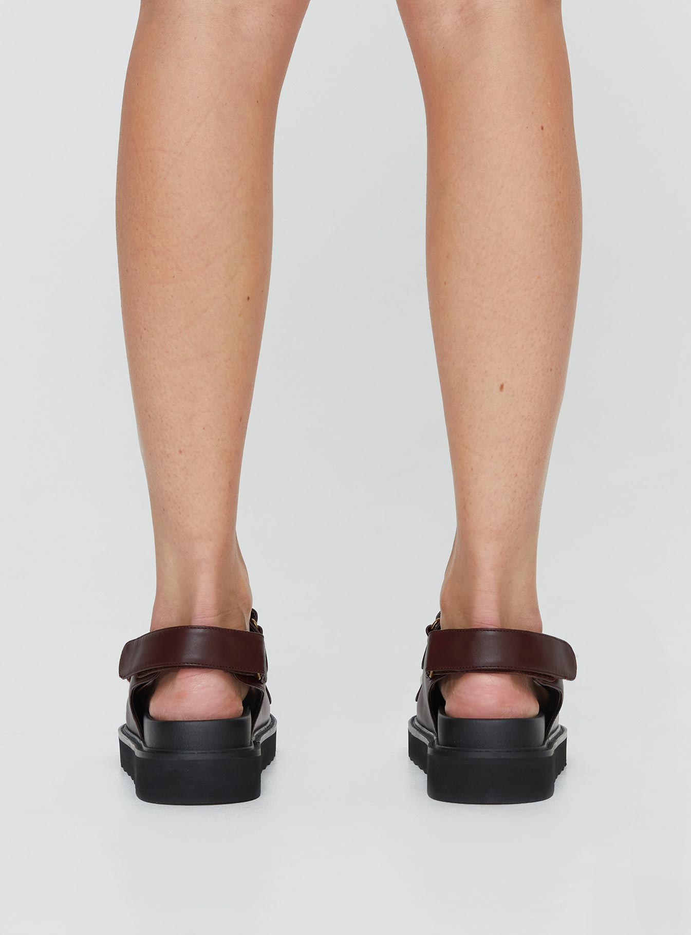 Sandals Faux leather material, twin velcro upper, chunky treaded sole, padded footbed Ankle strap with velcro fastening