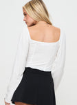White Long sleeve top Sweetheart neckline, ruched bust, elasticated shoulders, invisible zip fastening at side, lace detail, split hem