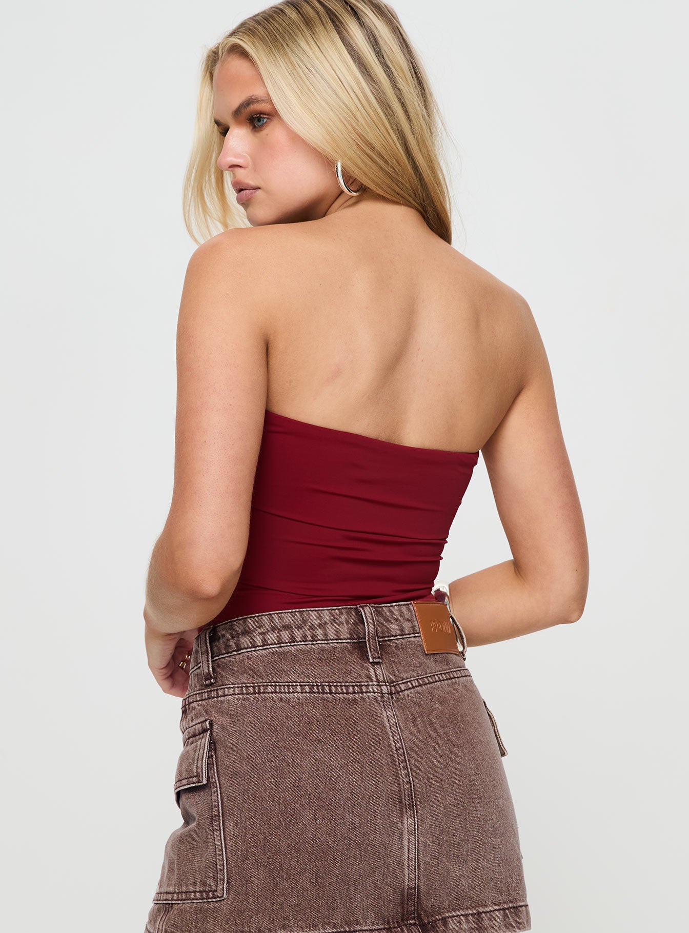 back view of model wearing Princess Polly Niner Strapless Bodysuit Burgundy Petite Sleeveless 