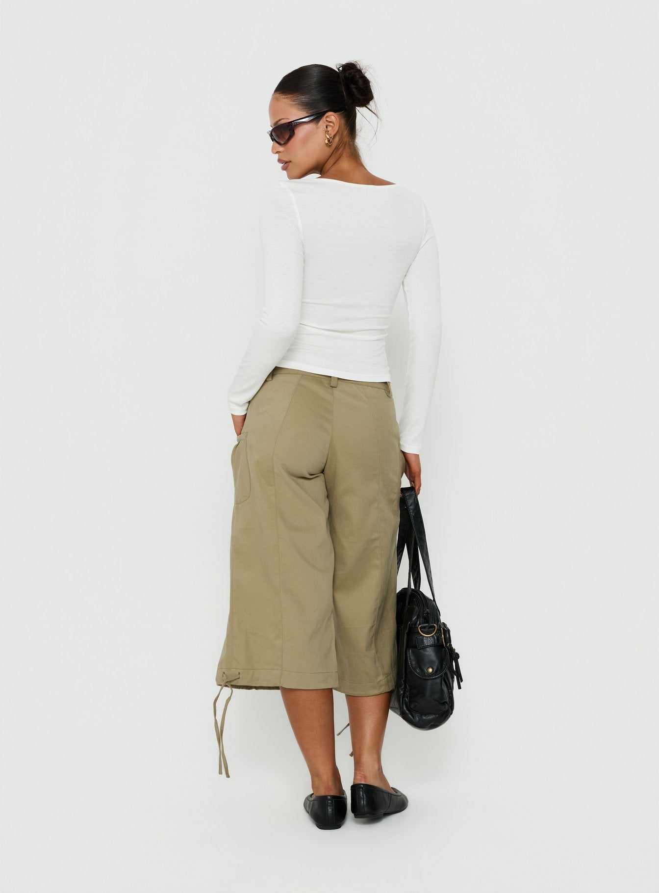 Presenting the Iria Capri Trouser Khaki womens-regular-pants with mid-rise waist back view of model wearing Princess Polly