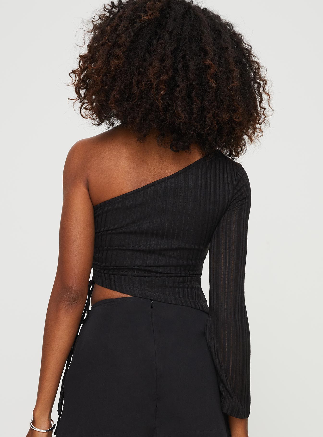 back view of model wearing Princess Polly Doulet One Shoulder Top Black Full Sleeves Asymmetric Neckline 