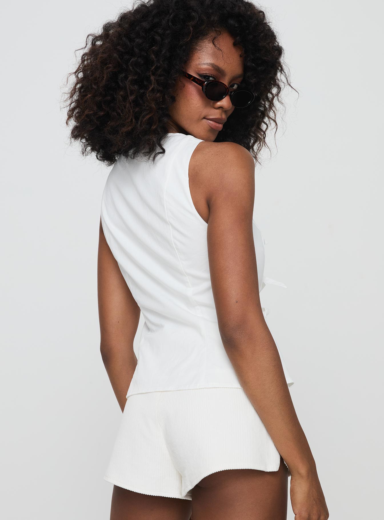 back view of model wearing Princess Polly Luminary Tie Up Top White Sleeveless Crew Neck 