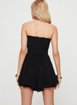 Strapless playsuit Shirred top, textured material, ruffle trim along neckline, V detail, layered ruffle hem  Good stretch, lined bottoms