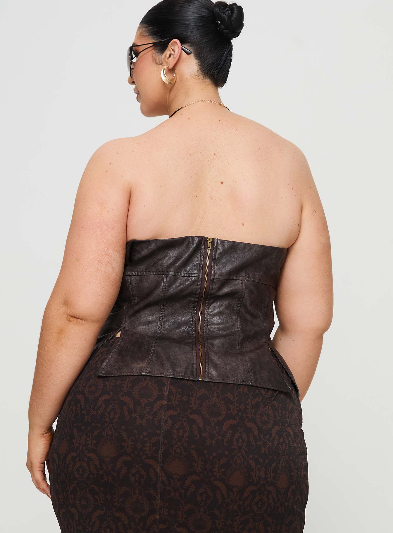 back view of model wearing Princess Polly Afraid Strapless Faux Leather Top Brown Curve Sleeveless straight 