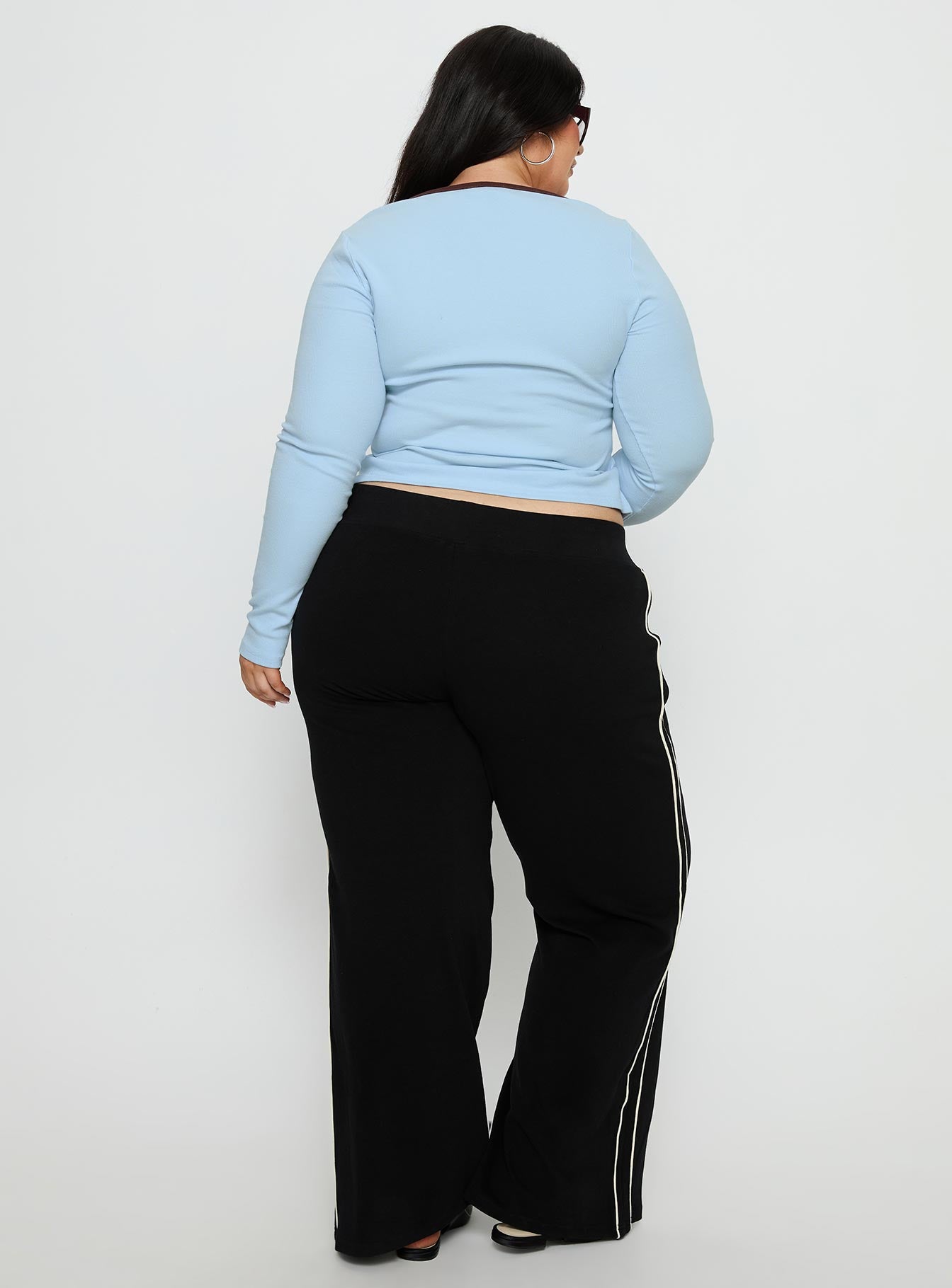 back view of model wearing Princess Polly Ascenda Straight Leg Track Pant Black Curve Mid Rise Pants 