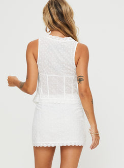 Two piece broderie anglaise set Crop top, Fixed shoulder straps, v-neckline, tie fastening at bust, split hem High rise mini skirt, invisible zip fastening at side
