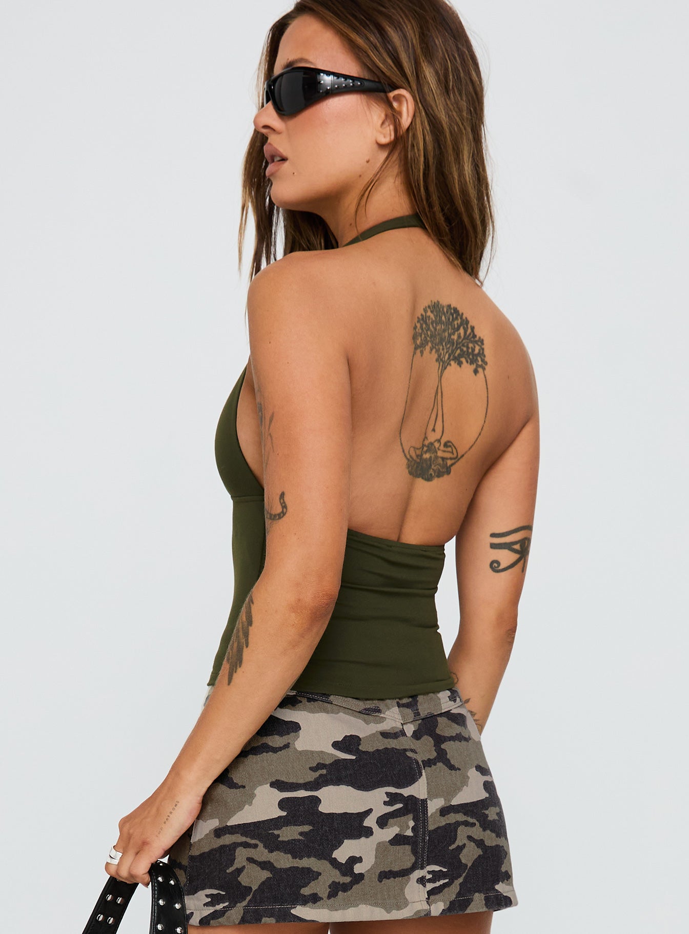 back view of model wearing Princess Polly Impress Me Halter Top Green Sleeveless Plunger 