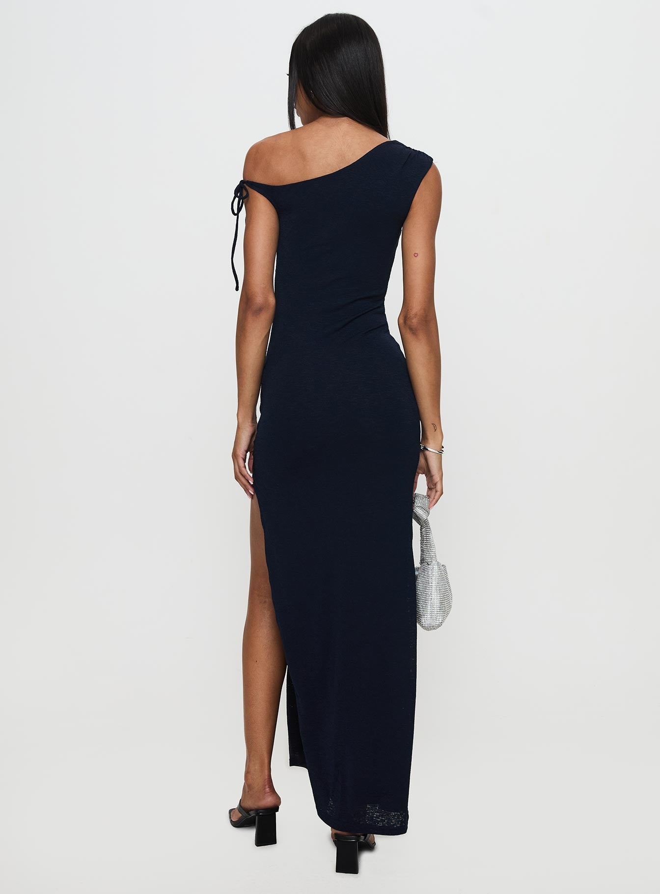 back view of model wearing Princess Polly Paislee Asymmetrical Maxi Dress Navy Asymmetric Neckline 