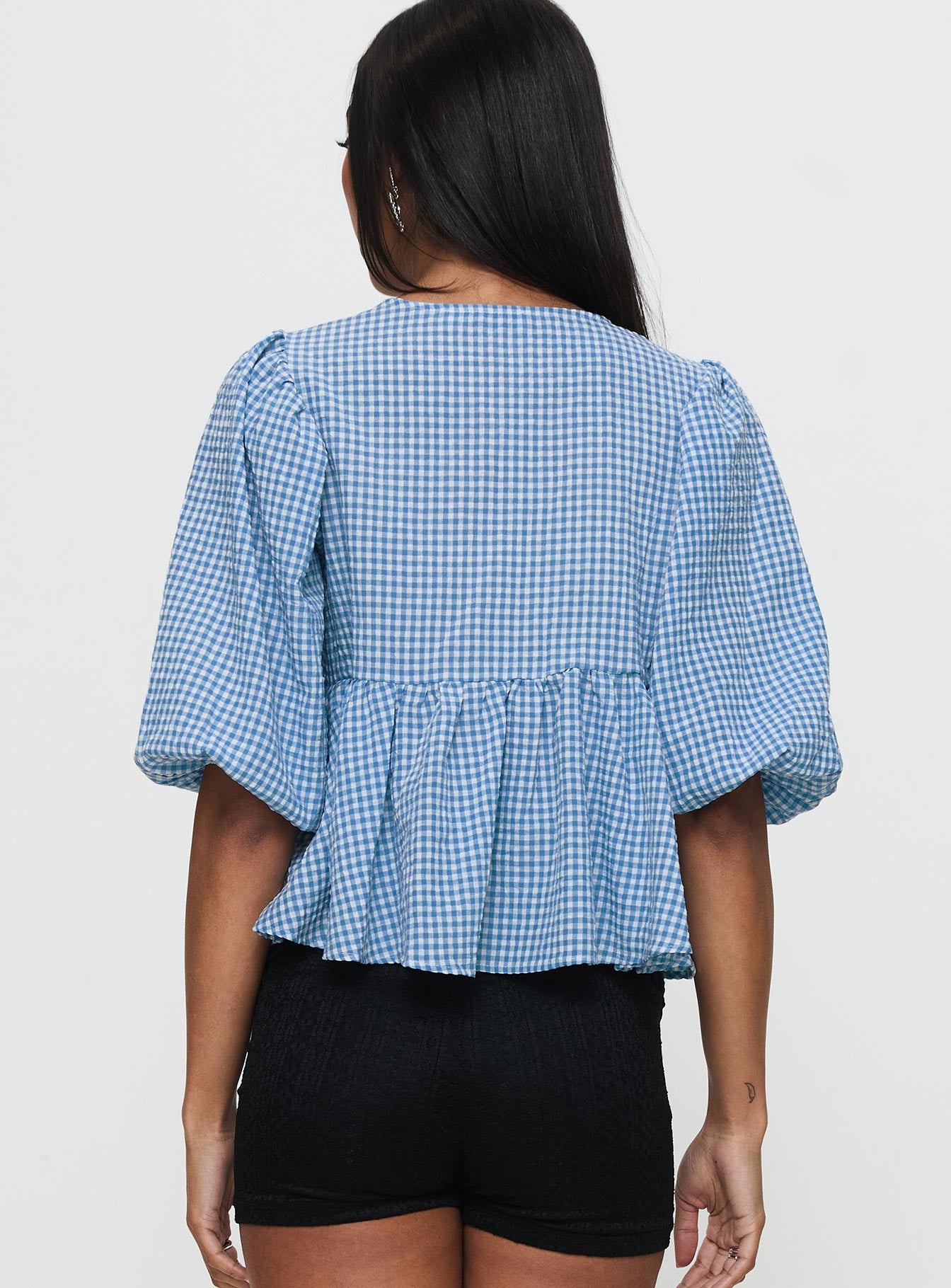 back view of model wearing Princess Polly Full House Tie Up Blouse Top Blue Plaid Half Sleeves Crew Neck 