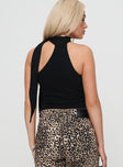 back view of model wearing Princess Polly Anderstone Neck Tie Top Black Sleeveless Asymmetric Neckline 