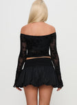 back view of model wearing Princess Polly French Exit Bubble Hem Skort Black High Waisted Shorts 