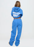 back view of model wearing Princess Polly Princess Polly Wide Leg Track Pant Bubble Text Blue High Waisted Pants 