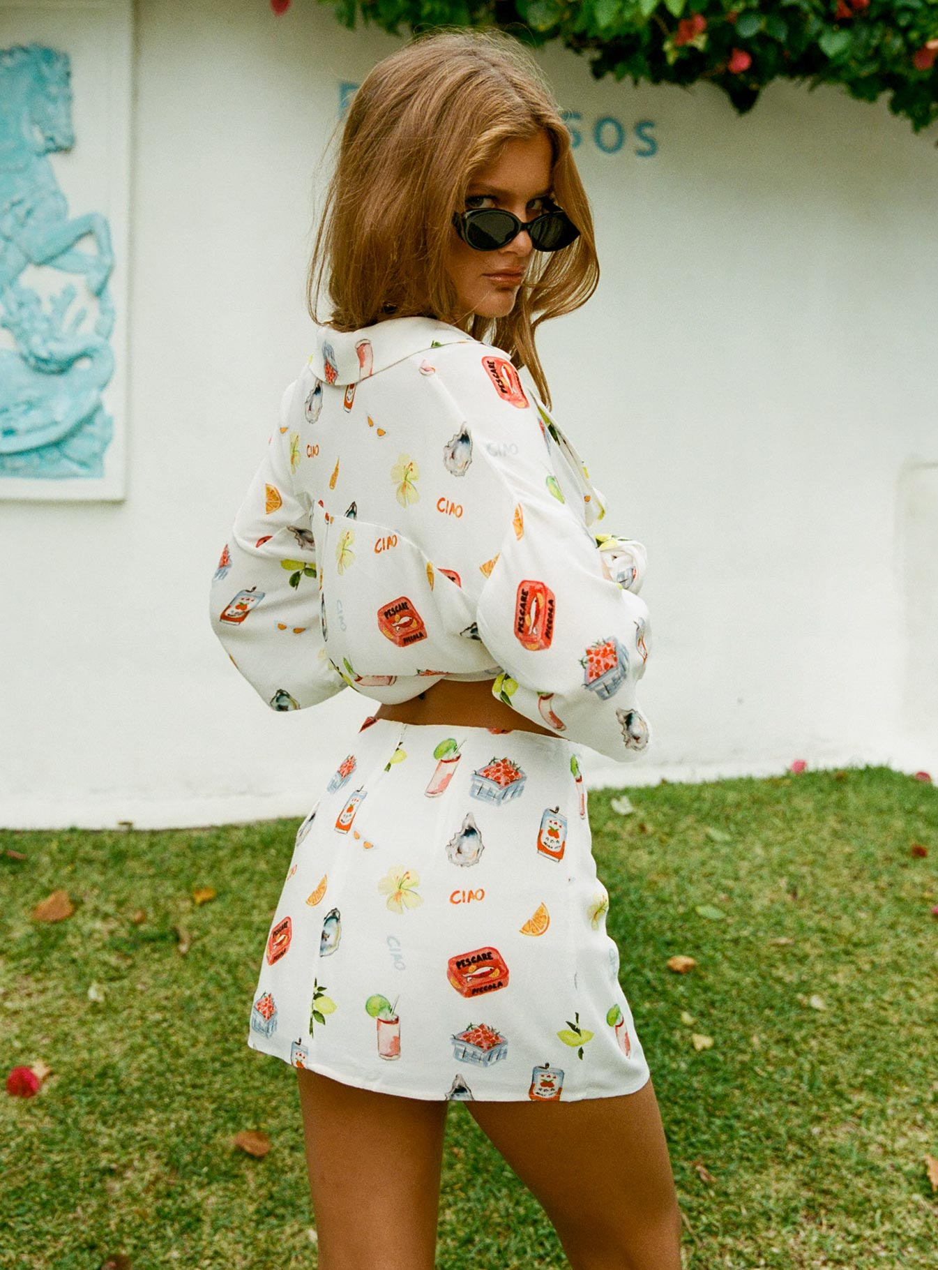 back view of model wearing Princess Polly Caraliia Mini Skirt White / Multi Mini Skirts 