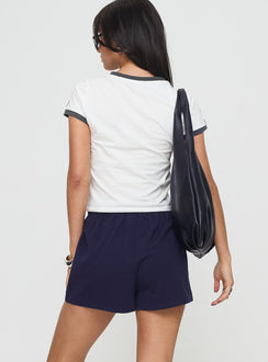 back view of model wearing Princess Polly Gavine Shorts Navy mid-rise 
