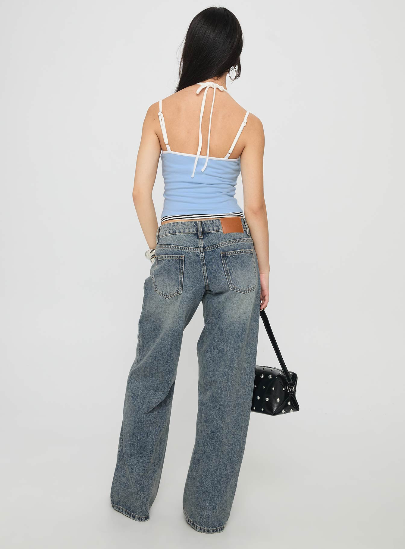 back view of model wearing Princess Polly Zaralyn Low Rise Wide Leg Jeans Mid Blue Wash Low Rise Jeans 