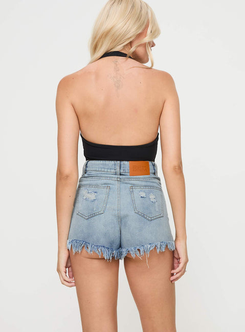 back view of model wearing Princess Polly Ridge Denim Shorts Mid Wash 