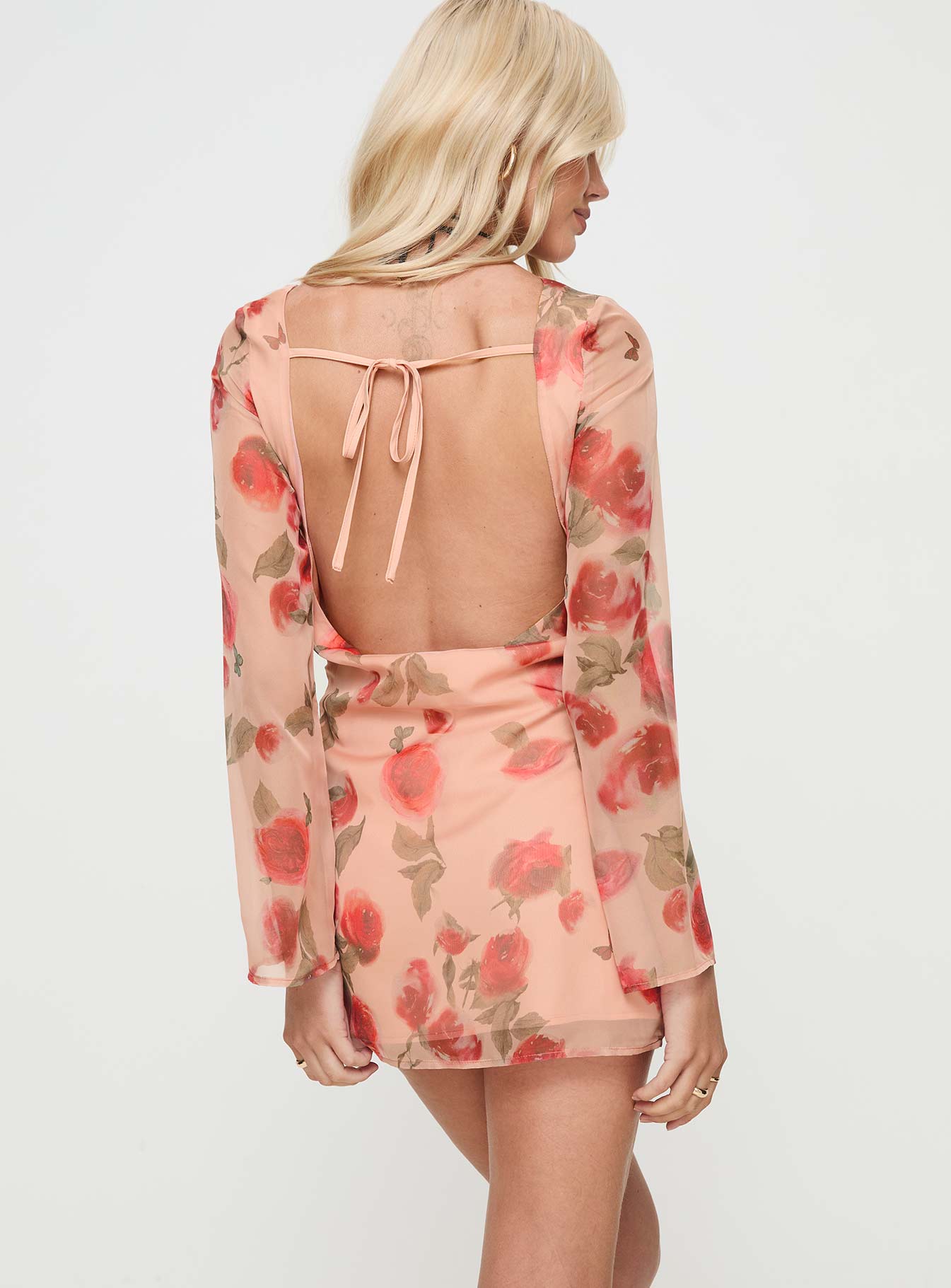 back view of model wearing Princess Polly Florinda Long Sleeve Mini Dress Pink Floral High Neck 