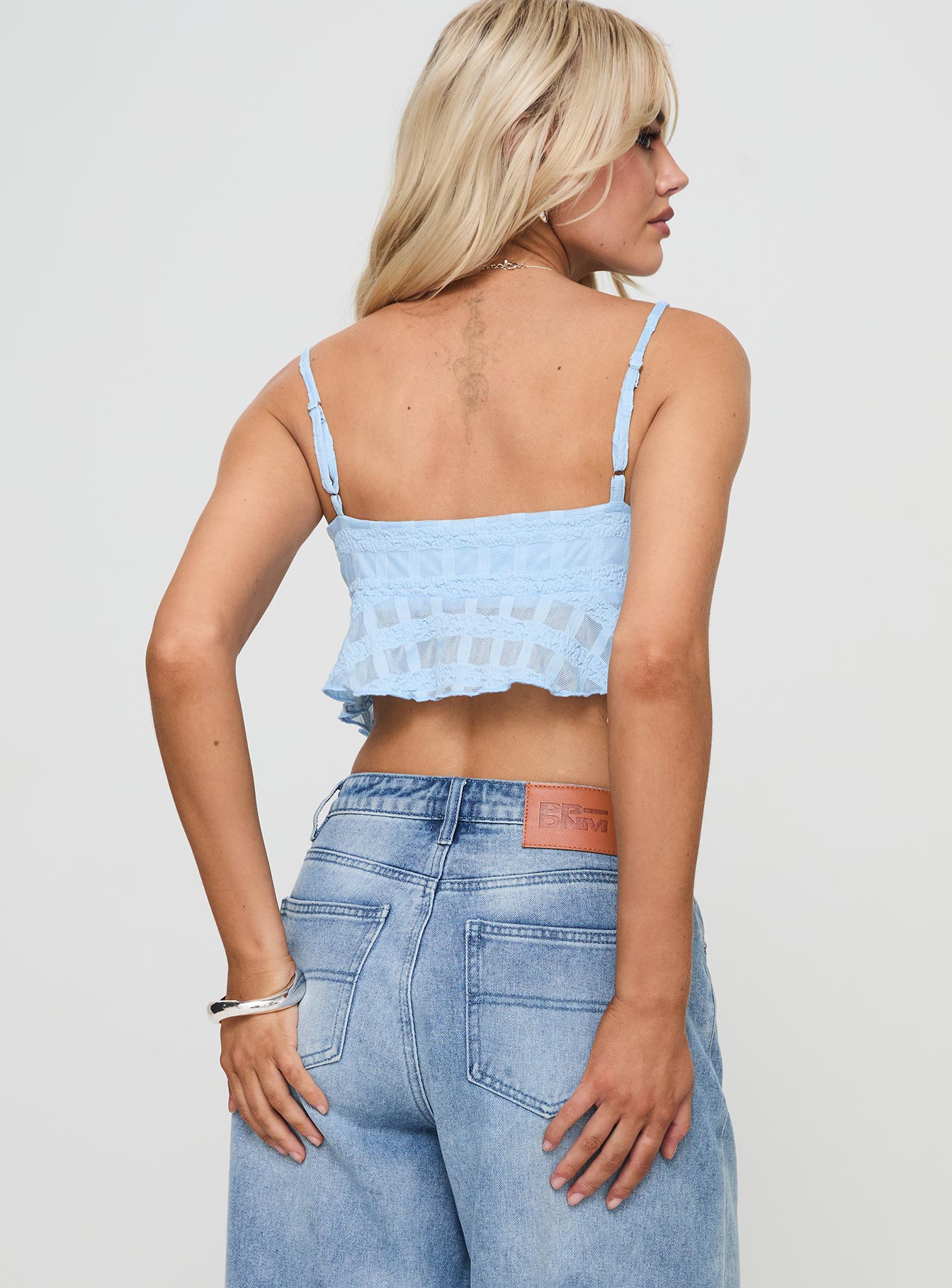 back view of model wearing Princess Polly Flicker Top Blue Sleeveless Sweetheart 