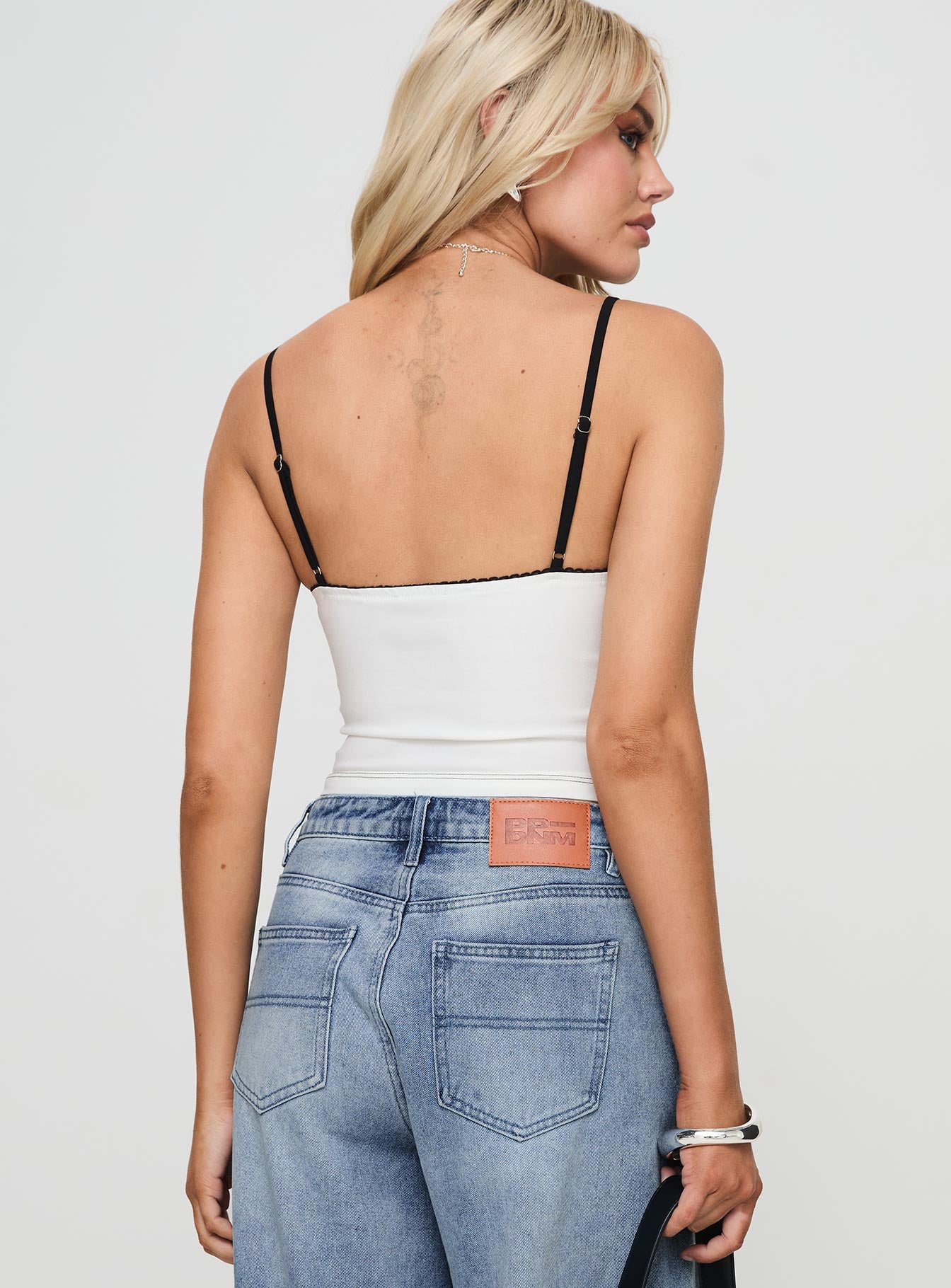 back view of model wearing Princess Polly Severas Top White Sleeveless Sweetheart 