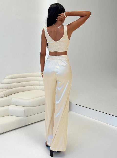 Matching set Silky material Crop top Fixed shoulder strap Invisible zip fastening at side Shirred back Pants Elasticated waistband Zip and button fastening Wide leg