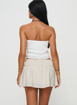 Low rise mini skirt Shirred waistband, tie detail at side Non-stretch material, fully lined