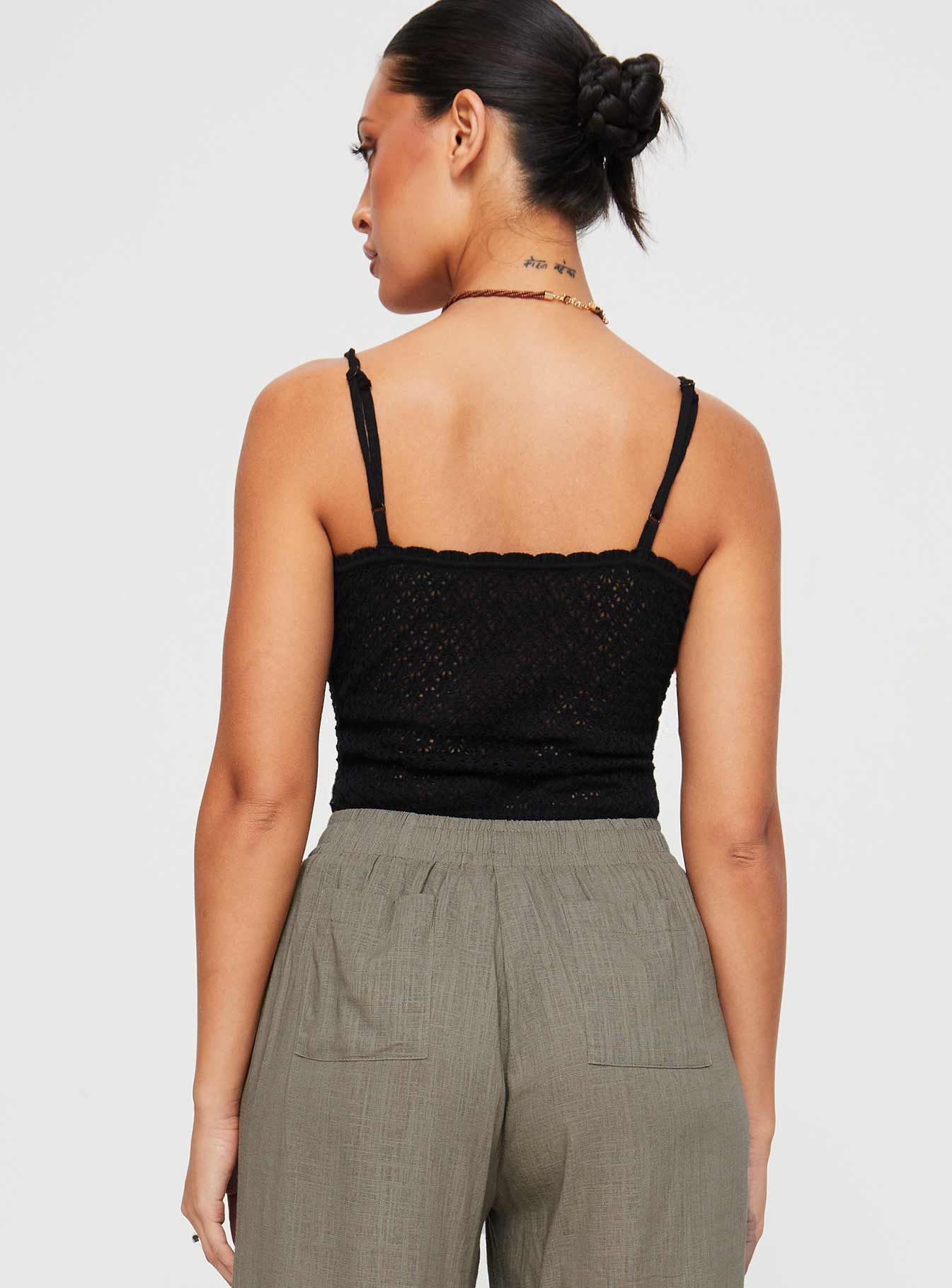 back view of model wearing Princess Polly Going For It Knit Bodysuit Black Sleeveless Asymmetric Neckline 