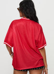 back view of model wearing Princess Polly Fenway Spirit Top Red Half Sleeves V-Neck 