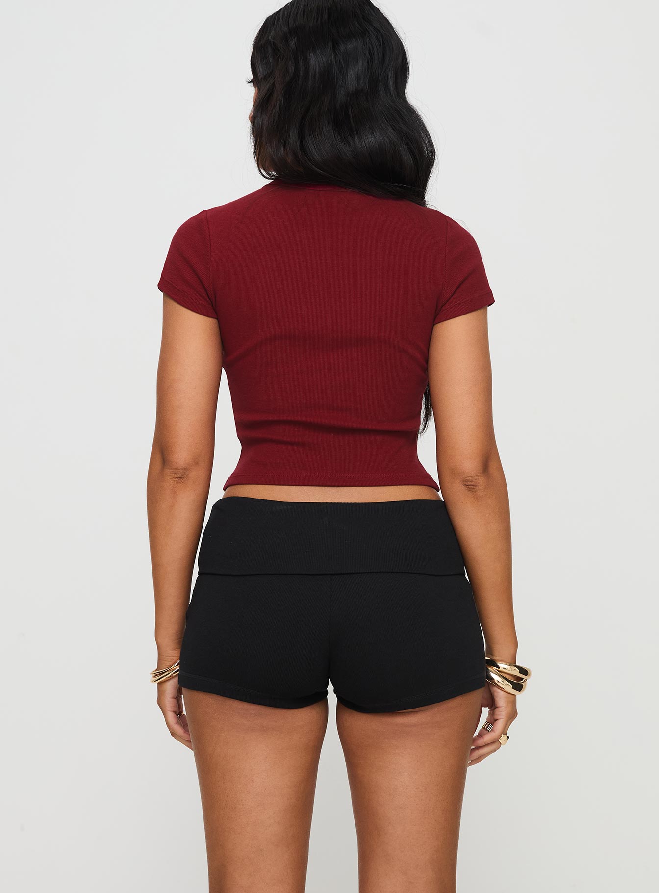 back view of model wearing Princess Polly Baseline Low Rise Rib Shorts Black High Waisted Shorts 