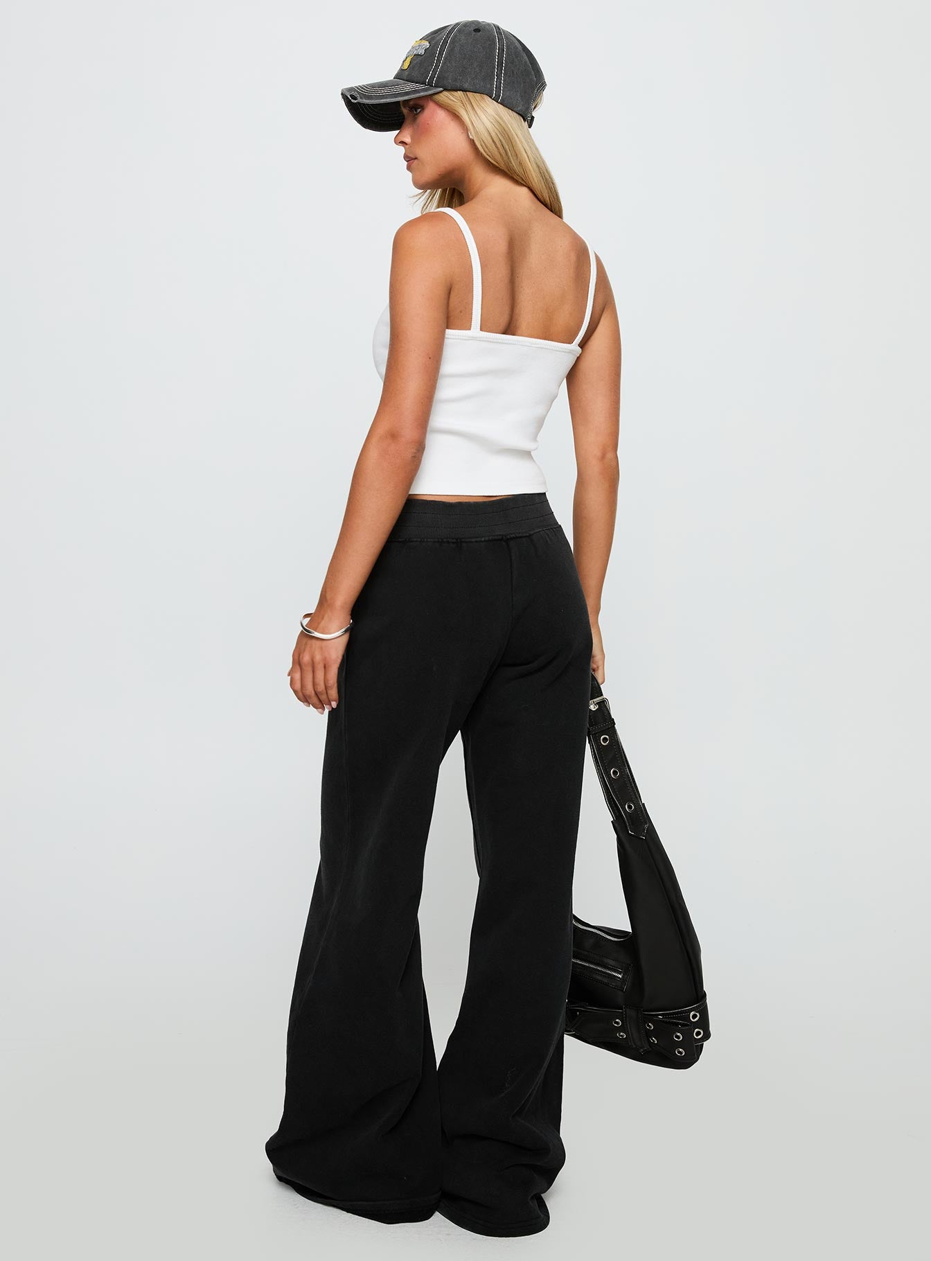 back view of model wearing Princess Polly Summits Flared Track Pants Washed Black High Waisted Pants 