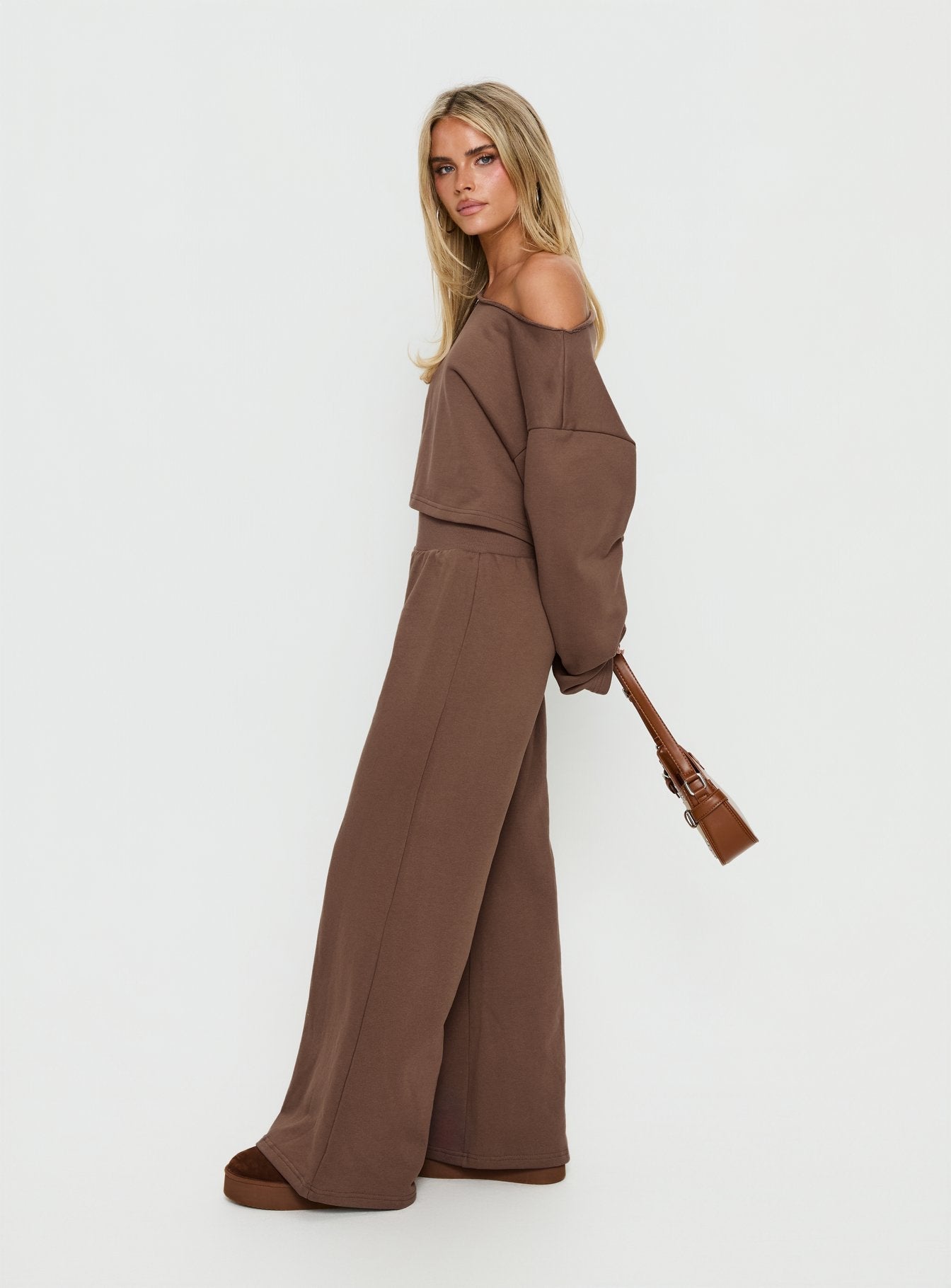 side view of model wearing Princess Polly Peaks Flared Track Pants Cocoa Mid Rise Pants 