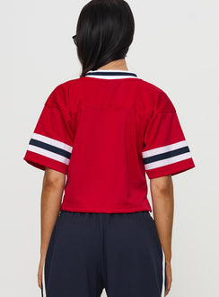 back view of model wearing Princess Polly U of A Football Jersey Red Half Sleeves V-Neck 