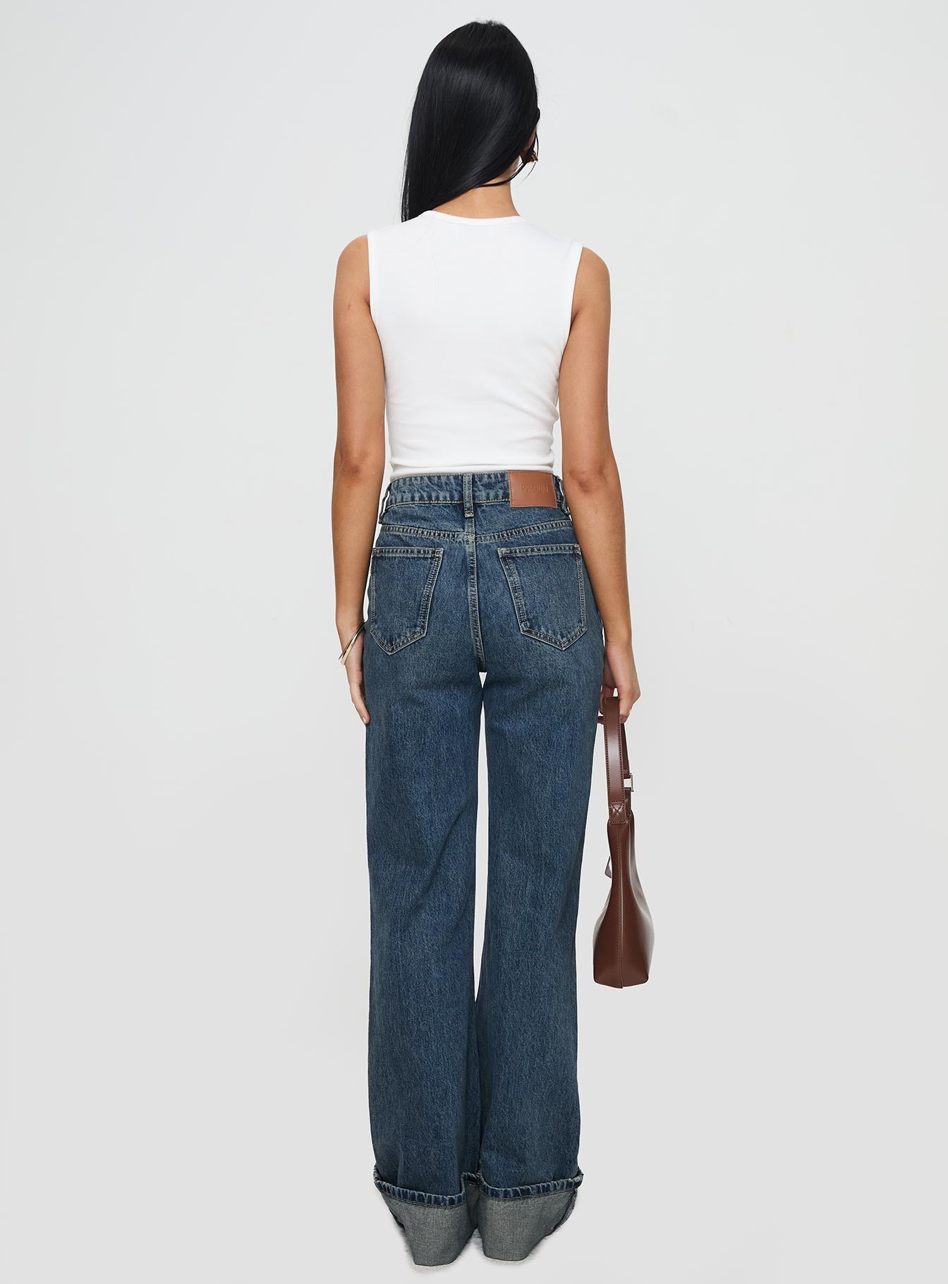 back view of model wearing Princess Polly Florida Keys Cuffed Jeans Mid Blue High Waisted 
