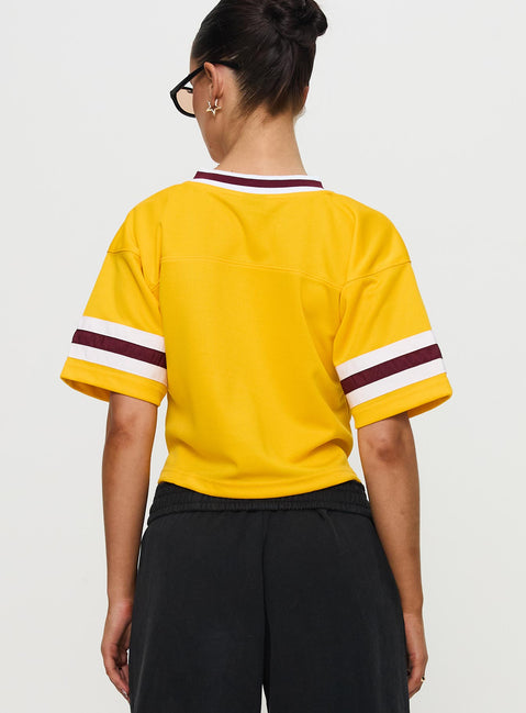 back view of model wearing Princess Polly ASU Football Jersey Gold Half Sleeves V-Neck 